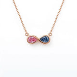 Discover a pink and blue pear-cut infinity pendant with smooth bezel settings. Personalize your gemstone pairing and metal with Gemlux Jewels.