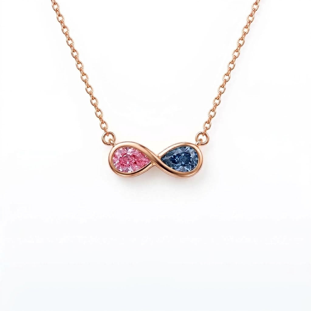 Discover a pink and blue pear-cut infinity pendant with smooth bezel settings. Personalize your gemstone pairing and metal with Gemlux Jewels.