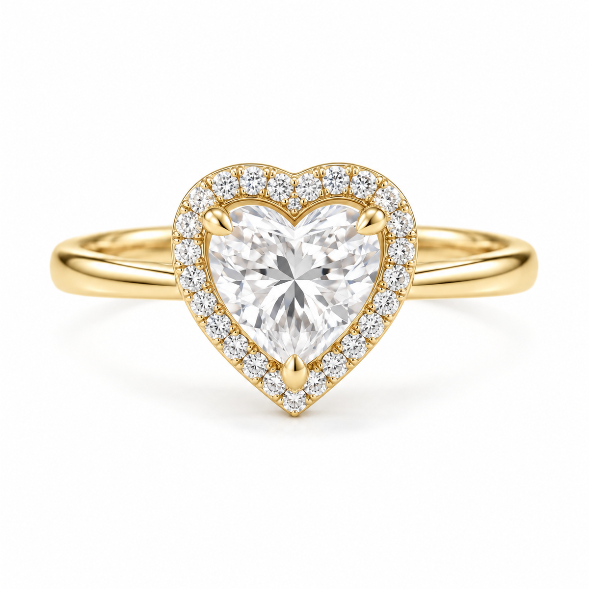 A heart-shaped diamond ring with a yellow gold halo and band, set against a clean white background.