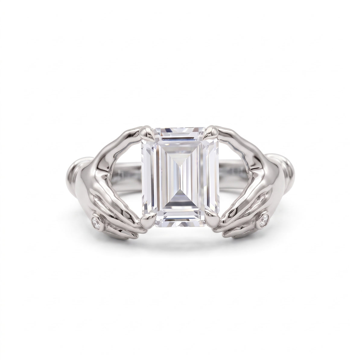 Emerald-cut lab-grown diamond engagement ring with a sculpted gold double-dolphin band and round diamond accents