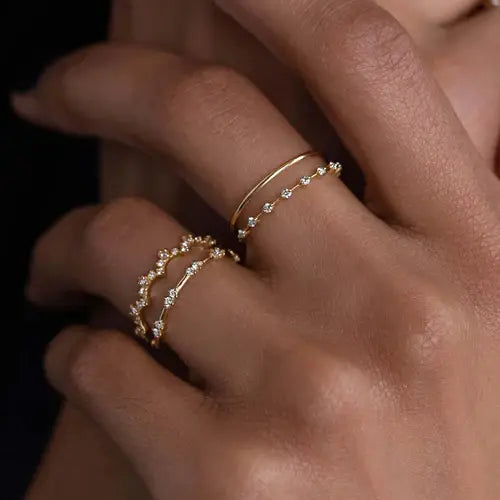 Curved diamond wedding band stacked with plain gold ring