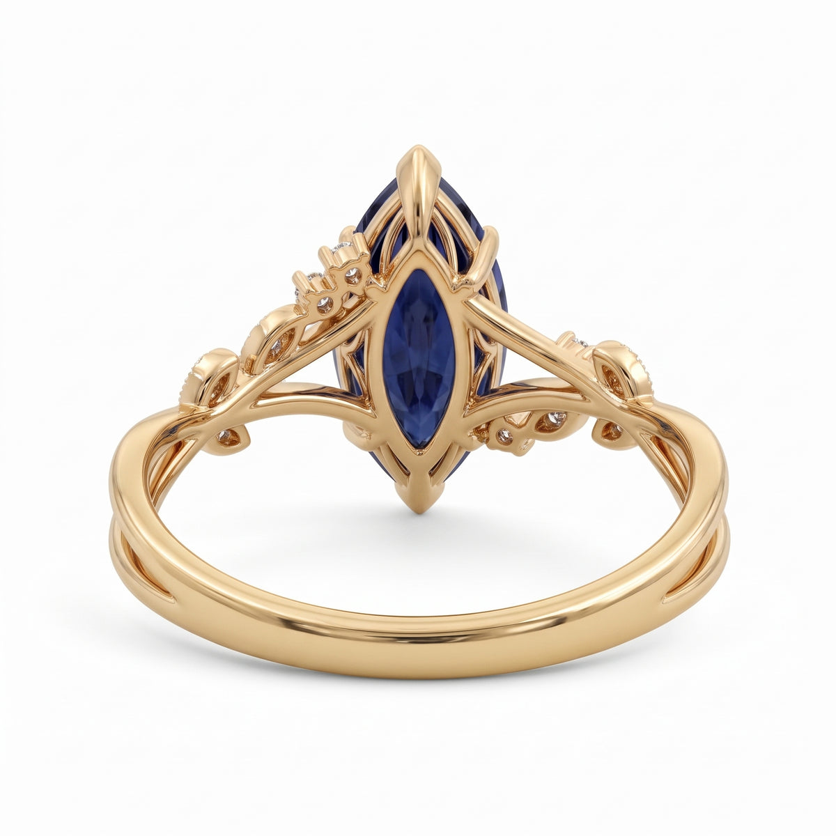 Deep-blue marquise gemstone ring with white-metal split shoulders, sparkling leaf-shaped settings and scattered round accents