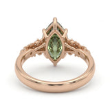Fancy green marquise-cut lab-grown diamond engagement ring with a vintage gold vine band and round diamond accents