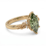 Fancy green marquise-cut lab-grown diamond engagement ring with a vintage gold vine band and round diamond accents