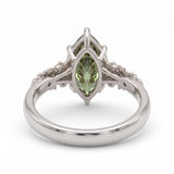 Fancy green marquise-cut lab-grown diamond engagement ring with a vintage gold vine band and round diamond accents