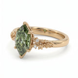 Fancy green marquise-cut lab-grown diamond engagement ring with a vintage gold vine band and round diamond accents