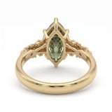 Fancy green marquise-cut lab-grown diamond engagement ring with a vintage gold vine band and round diamond accents