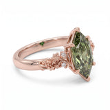 Fancy green marquise-cut lab-grown diamond engagement ring with a vintage gold vine band and round diamond accents