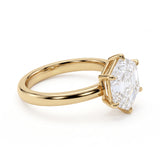 Hexagon step-cut lab-grown diamond solitaire engagement ring with a six-prong setting and polished yellow-gold band.