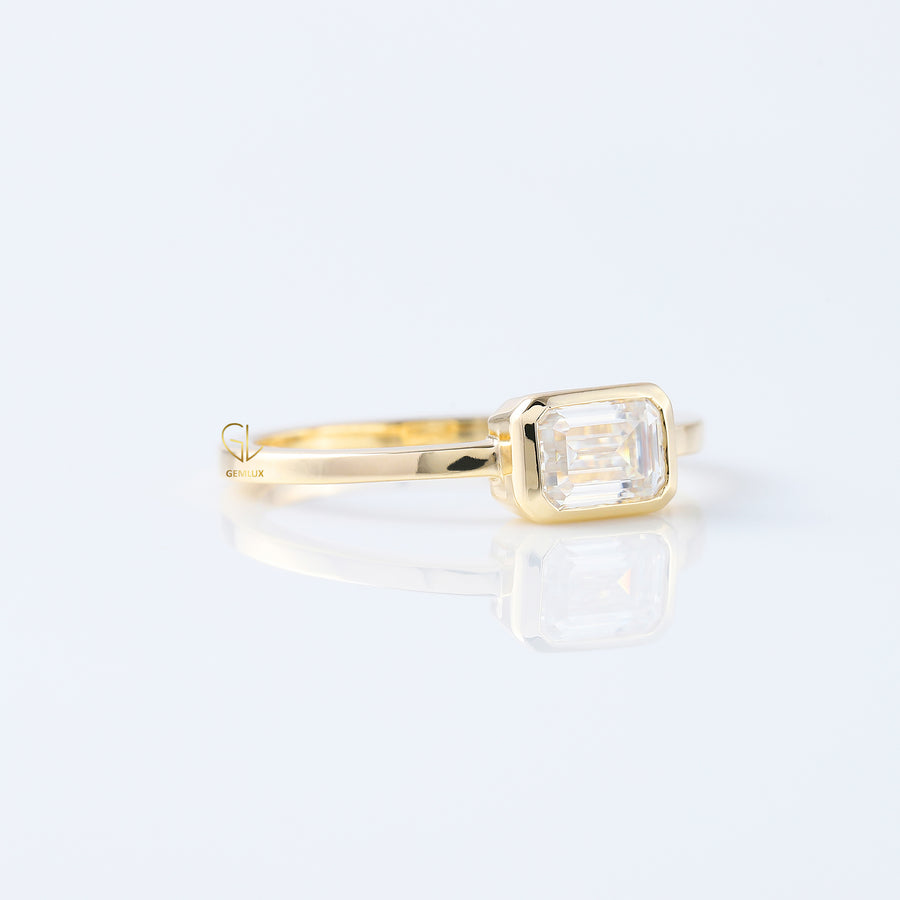 East to West Emarald Cut Moissanite Bezel Set Solitaire Ring