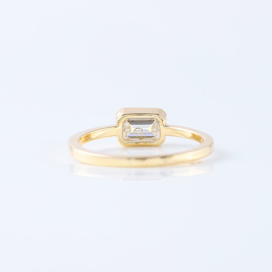 East to West Emarald Cut Moissanite Bezel Set Solitaire Ring