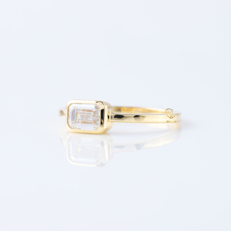 East to West Emarald Cut Moissanite Bezel Set Solitaire Ring