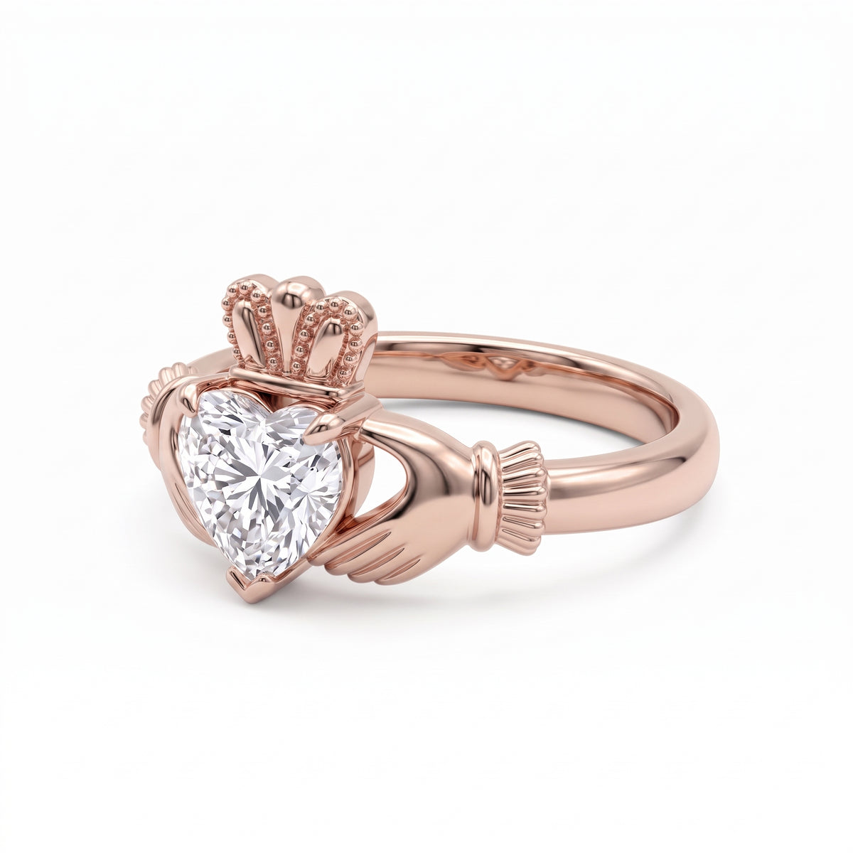 Heart-cut moissanite Irish Claddagh engagement ring with sculpted hands and crown in yellow gold