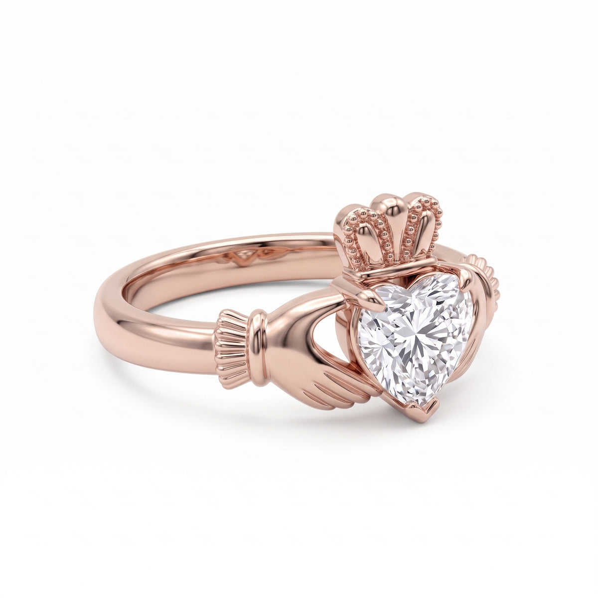 Heart-cut moissanite Irish Claddagh engagement ring with sculpted hands and crown in yellow gold