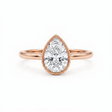 Pear-cut lab-grown diamond bezel solitaire engagement ring with fine milgrain detailing and a polished yellow-gold band.