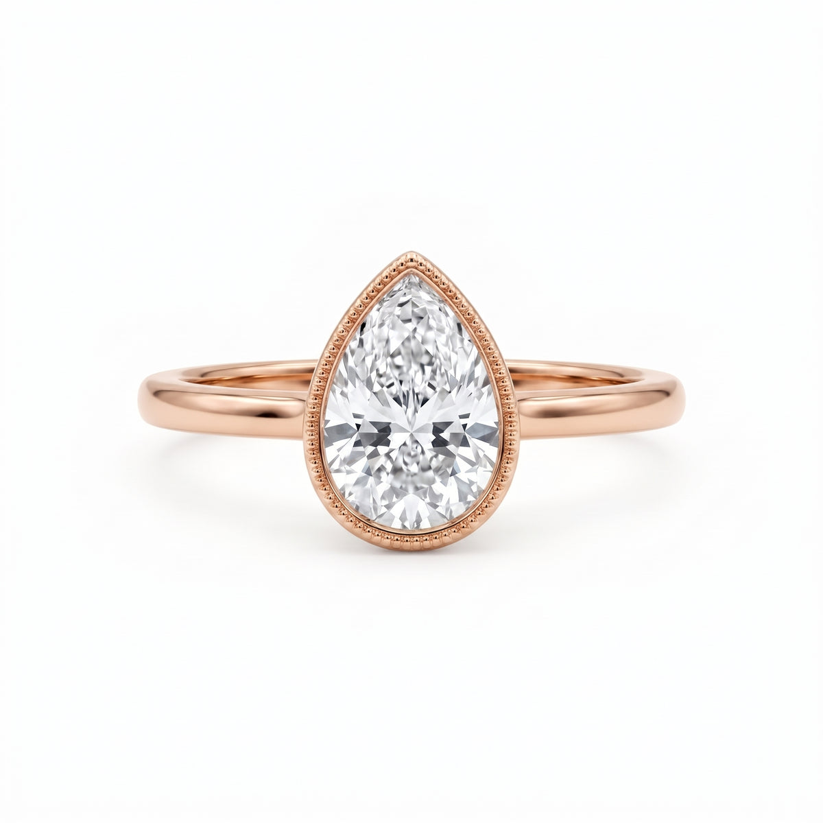 Pear-cut lab-grown diamond bezel solitaire engagement ring with fine milgrain detailing and a polished yellow-gold band.