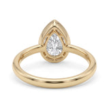 Pear-cut lab-grown diamond bezel solitaire engagement ring with fine milgrain detailing and a polished yellow-gold band.