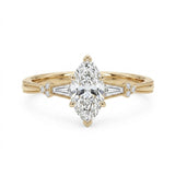 Marquise-cut lab-grown diamond engagement ring with tapered baguette side stones, round accents and a milgrain split-shank yellow-gold band.