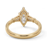 Marquise-cut lab-grown diamond engagement ring with tapered baguette side stones, round accents and a milgrain split-shank yellow-gold band.