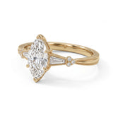 Marquise-cut lab-grown diamond engagement ring with tapered baguette side stones, round accents and a milgrain split-shank yellow-gold band.