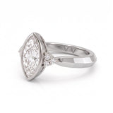 Bezel set marquise lab grown diamond engagement ring with round cluster side stones in white gold