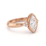 Bezel set marquise lab grown diamond engagement ring with round cluster side stones in white gold