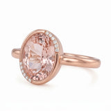 Fancy pink oval lab-grown diamond partial-bezel engagement ring with pavé accents