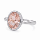 Fancy pink oval lab-grown diamond partial-bezel engagement ring with pavé accents