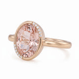Fancy pink oval lab-grown diamond partial-bezel engagement ring with pavé accents