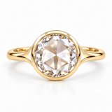 Round rose-cut lab-grown diamond solitaire ring with a smooth bezel setting and sculpted polished white-metal band