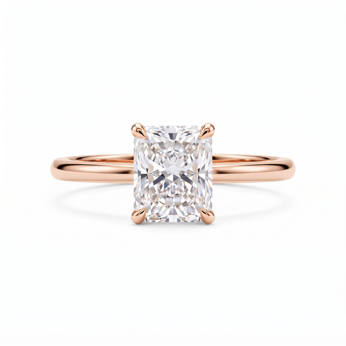 Elongated radiant-cut lab-grown diamond solitaire engagement ring with four prongs and a polished yellow-gold band.