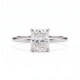Elongated radiant-cut lab-grown diamond solitaire engagement ring with four prongs and a polished yellow-gold band.