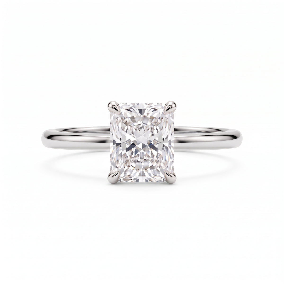 Elongated radiant-cut lab-grown diamond solitaire engagement ring with four prongs and a polished yellow-gold band.