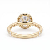 Round-cut lab-grown diamond halo engagement ring with a pavé diamond band, shown in polished yellow gold on a white background.