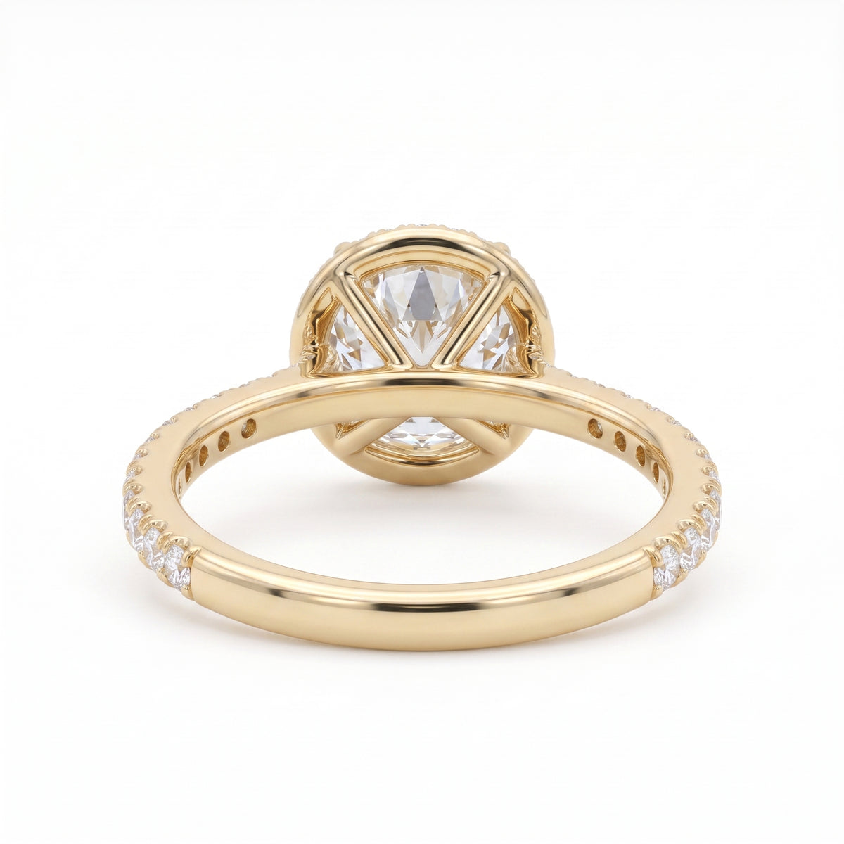 Round-cut lab-grown diamond halo engagement ring with a pavé diamond band, shown in polished yellow gold on a white background.