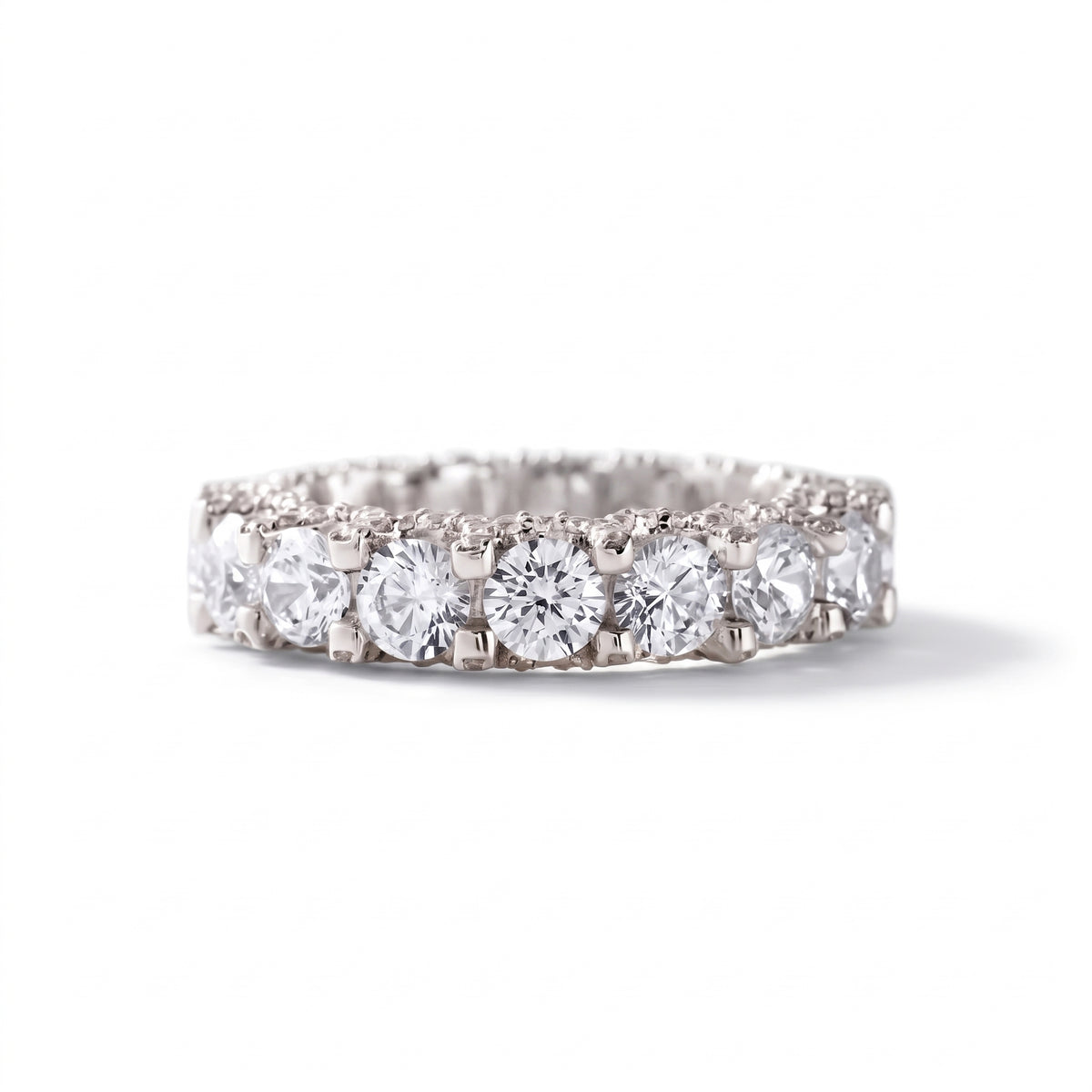 Round cut moissanite full eternity wedding band in white gold with prong set stones
