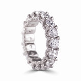 Round cut moissanite full eternity wedding band in white gold with prong set stones