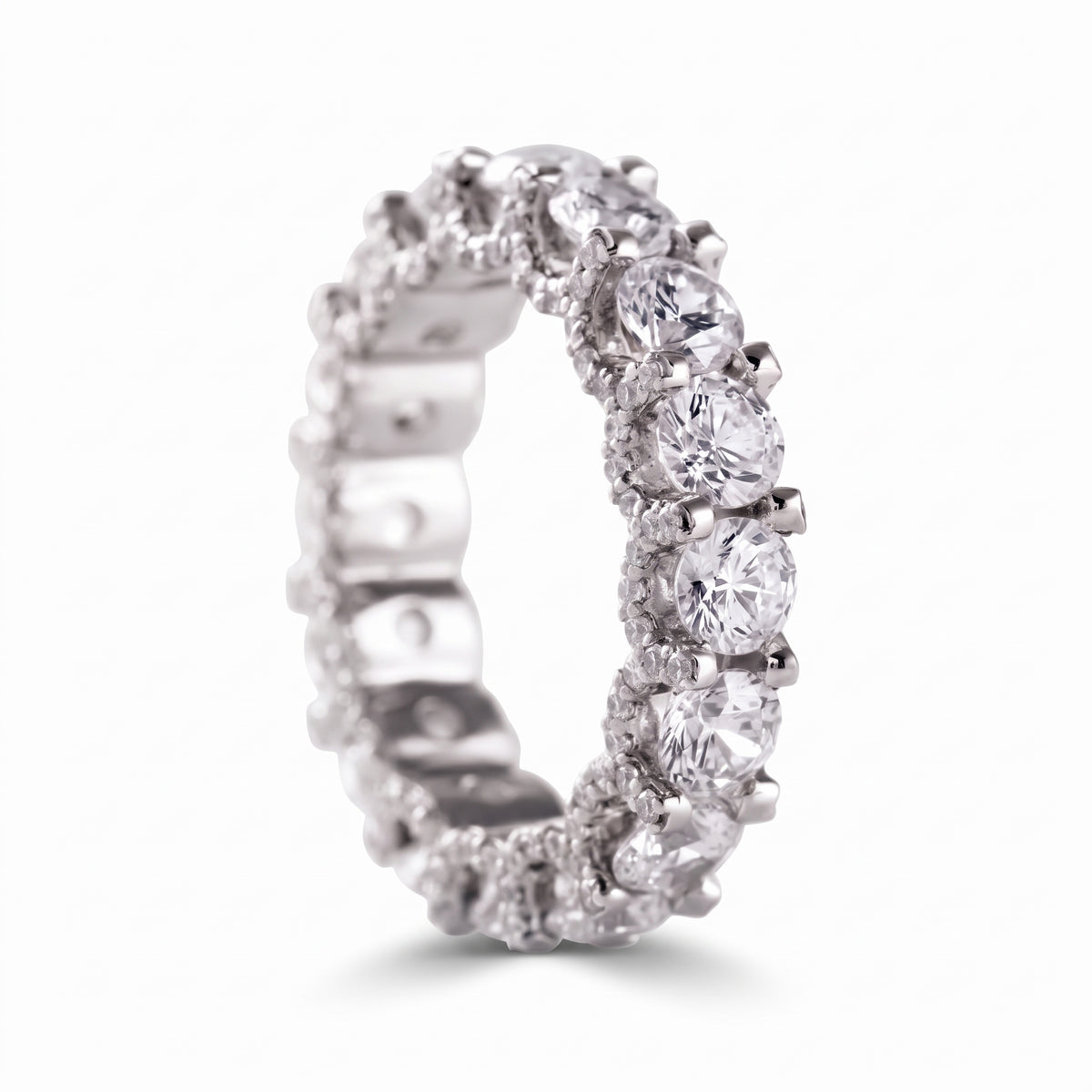 Round cut moissanite full eternity wedding band in white gold with prong set stones