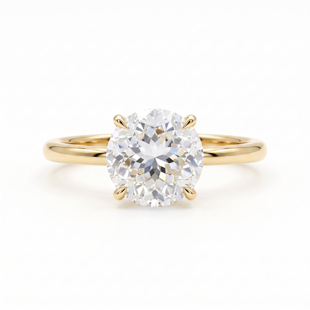 Round Portuguese-cut lab-grown diamond solitaire engagement ring with a four-prong setting and polished yellow-gold band.