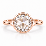 Round rose-cut lab-grown diamond solitaire ring with a smooth bezel setting and sculpted polished white-metal band