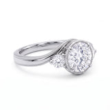 Round-cut lab-grown diamond three-stone bypass engagement ring with curved band