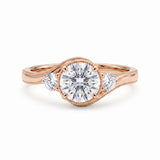 Round-cut lab-grown diamond three-stone bypass engagement ring with curved band