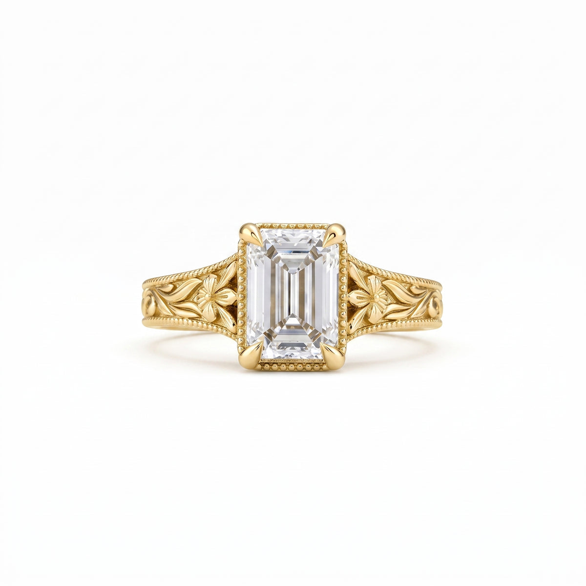 Vintage emerald-cut lab-grown diamond engagement ring with floral filigree, leaf engraving and milgrain detailing in polished yellow gold.