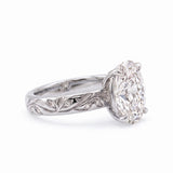Oval-cut lab-grown diamond botanical engagement ring with leaf and vine band
