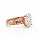 Oval-cut lab-grown diamond botanical engagement ring with leaf and vine band