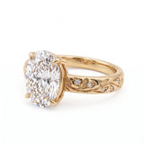 Oval-cut lab-grown diamond botanical engagement ring with leaf and vine band