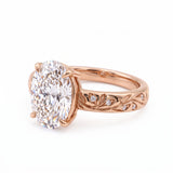 Oval-cut lab-grown diamond botanical engagement ring with leaf and vine band
