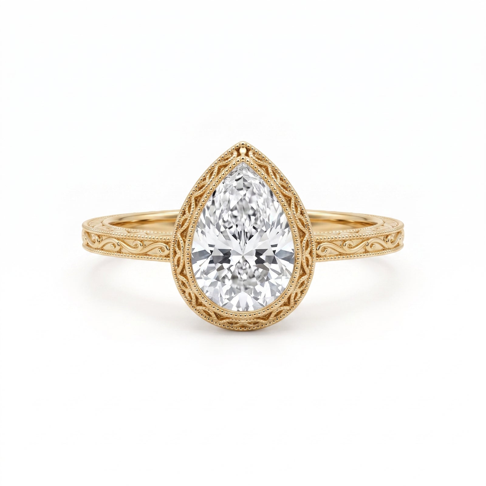 Vintage pear-cut lab-grown diamond bezel engagement ring with milgrain detailing and an engraved yellow-gold filigree band.