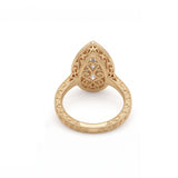 Vintage pear-cut lab-grown diamond bezel engagement ring with milgrain detailing and an engraved yellow-gold filigree band.