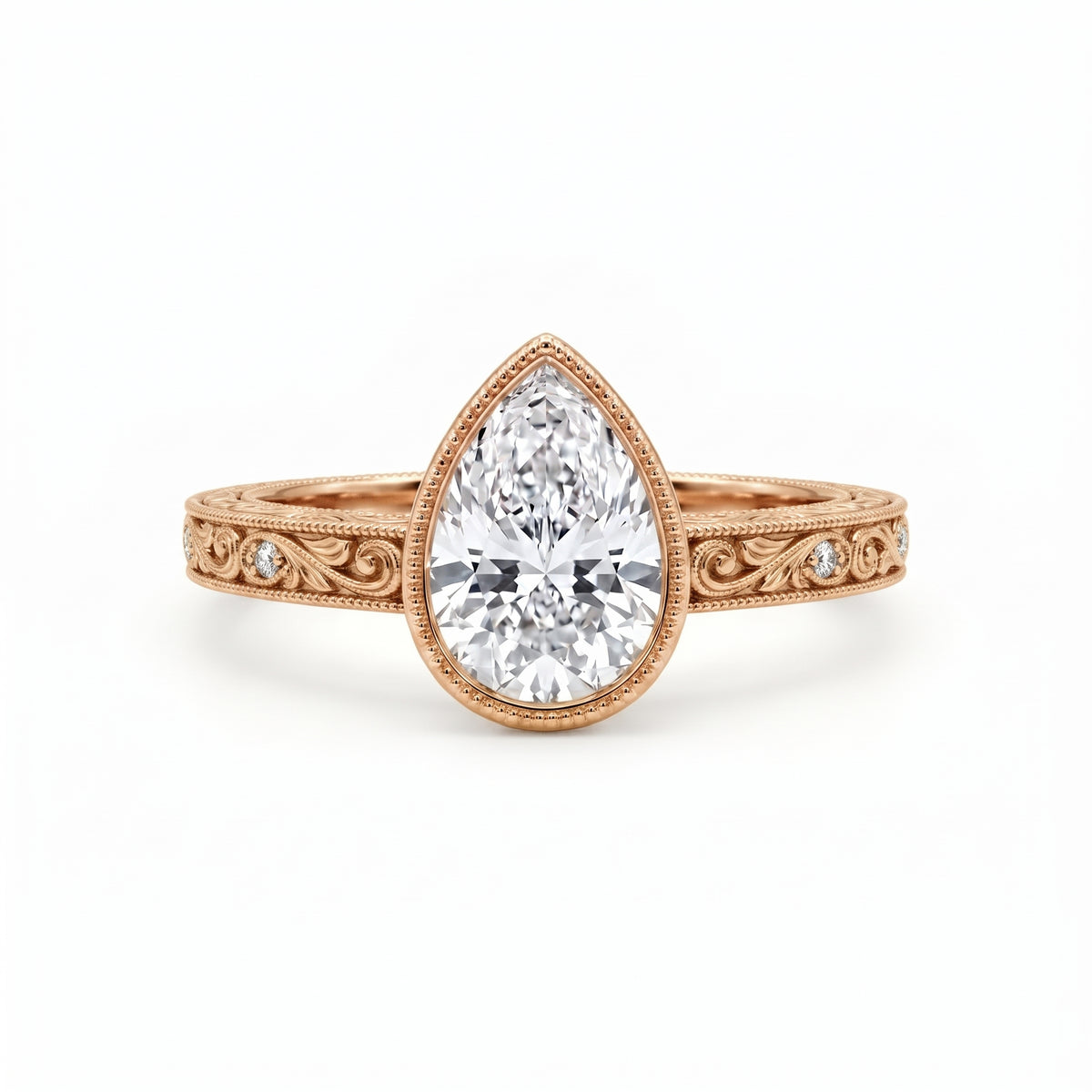 Vintage pear-cut lab-grown diamond bezel engagement ring with milgrain, scroll filigree and round diamond accents on a yellow-gold band.